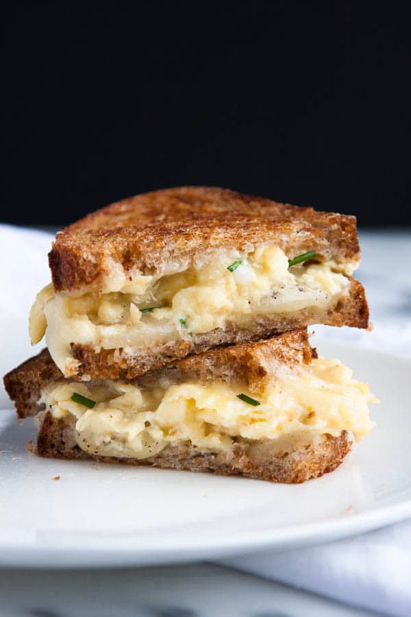 Grilled Cheese and Egg Sandwiches: fluffy scrambled eggs are smothered with melty mozzarella and sharp cheddar cheeses, nestled between two slices of buttery toasted bread. 