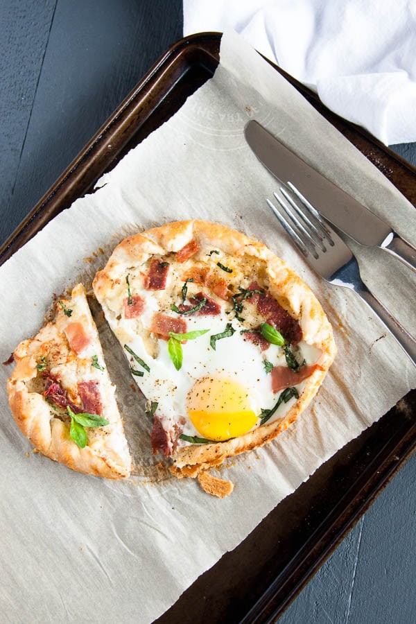 A cheesy Breakfast Galette wrapped in sour cream pastry with an egg baked onto it - a special weekend brunch!
