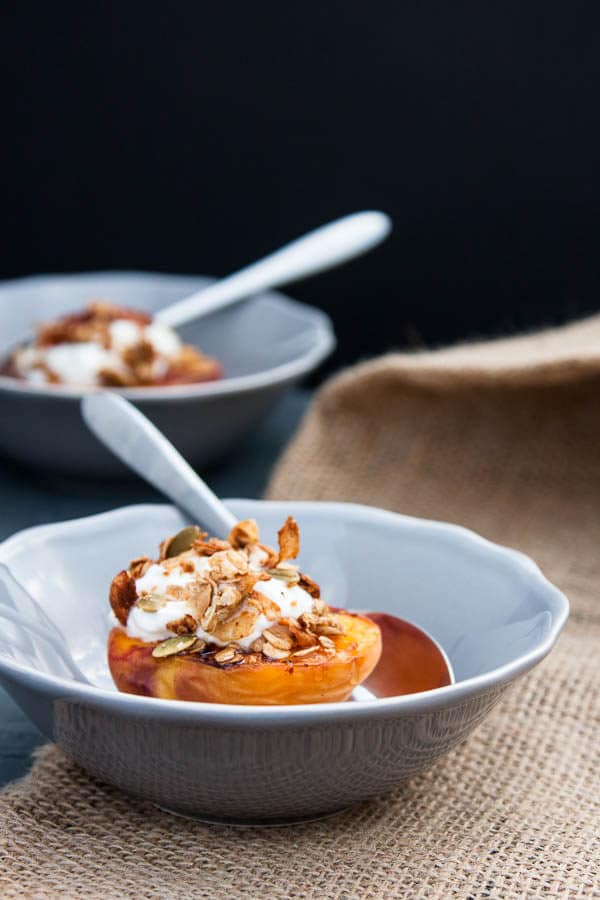 Grilled Peach Halves with Granola and Honey make a special variation on a fruit and granola breakfast - or swap the yogurt with vanilla ice cream for a light summer dessert!