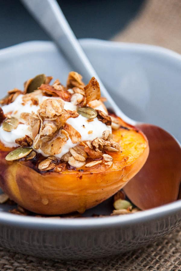 Grilled Peach Halves with Granola and Honey make a special variation on a fruit and granola breakfast - or swap the yogurt with vanilla ice cream for a light summer dessert!