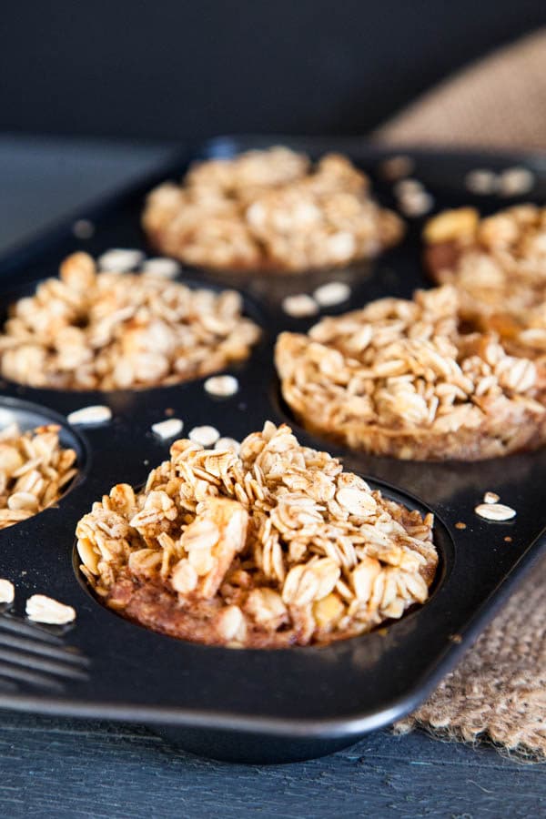 Baked Apple Cinnamon Oatmeal is prepared in muffin cups to take to go! | Breakfast for Dinner