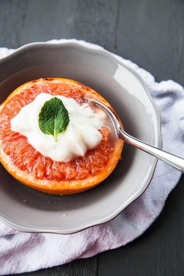 Warm caramelized broiled grapefruit is served with a dollop of Greek yogurt and a drizzle of honey, that tastes like dessert for breakfast.