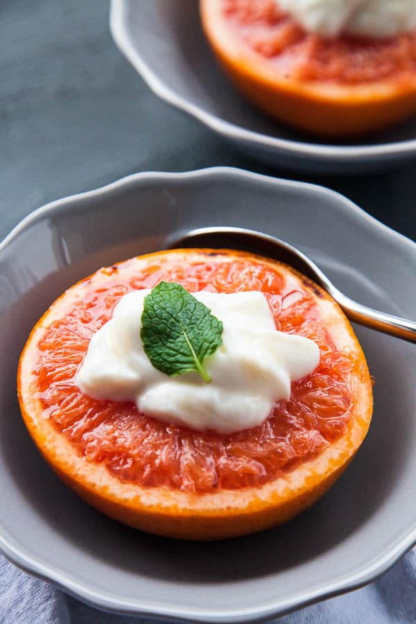 Warm caramelized broiled grapefruit is served with a dollop of Greek yogurt and a drizzle of honey, that tastes like dessert for breakfast.