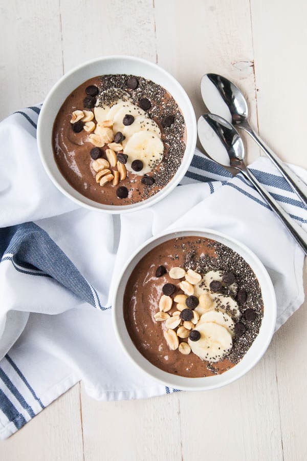 This Chocolate Peanut Butter Smoothie Bowl tastes like a Reese's peanut butter cup in a bowl - but is so healthy! Try it for breakfast or a healthy dessert.
