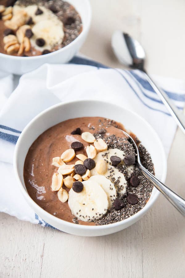 This Chocolate Peanut Butter Smoothie Bowl tastes like a Reese's peanut butter cup in a bowl - but is so healthy! Try it for breakfast or a healthy dessert.