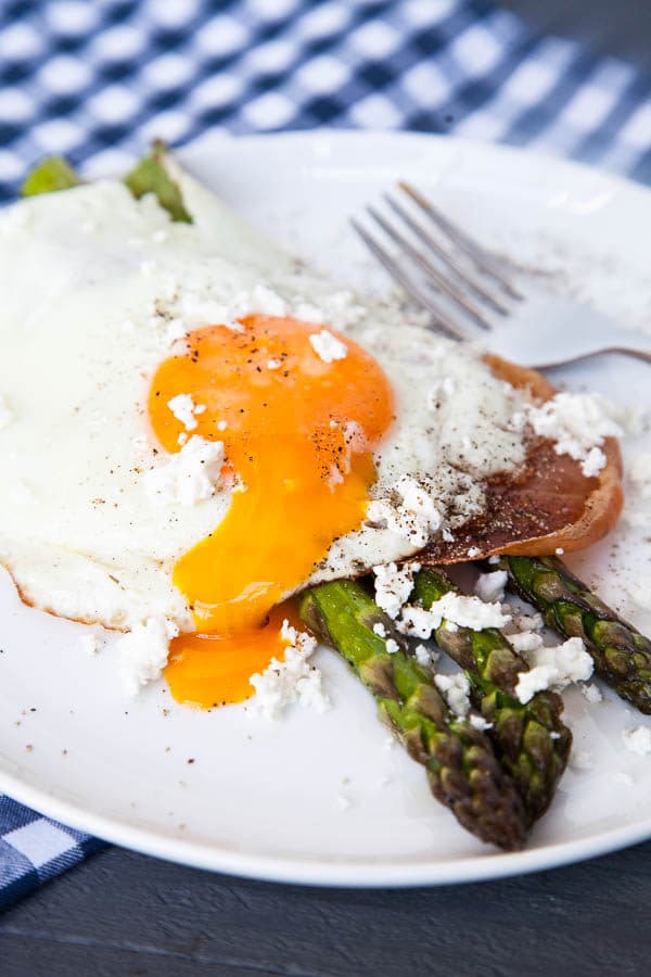 This is a simple sheet pan breakfast celebrating the Spring flavours of fresh asparagus. Roasted asparagus sprigs are stacked with crispy prosciutto, a soft fried egg, and crumbles of creamy goat cheese and it is the perfect combination of roasty, salty, and creamy.