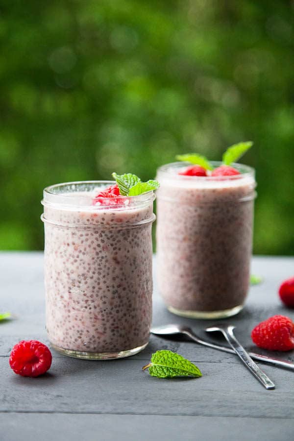 Beautiful pink berries are stirred in with chia seeds and milk to create a simple and nutritious Raspberry Chia Pudding breakfast.