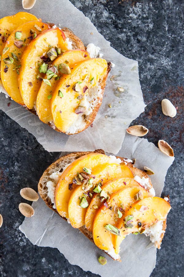 Enjoy peach ricotta toast for breakfast at the height of peach season - juicy sweet peaches are paired with creamy ricotta and crunchy salted pistachios.