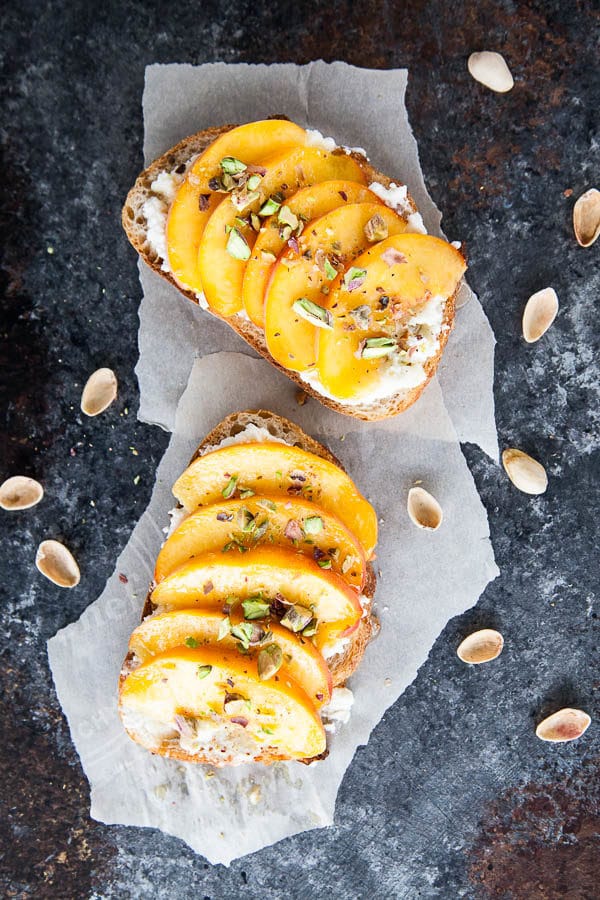 Enjoy peach ricotta toast for breakfast at the height of peach season - juicy sweet peaches are paired with creamy ricotta and crunchy salted pistachios.