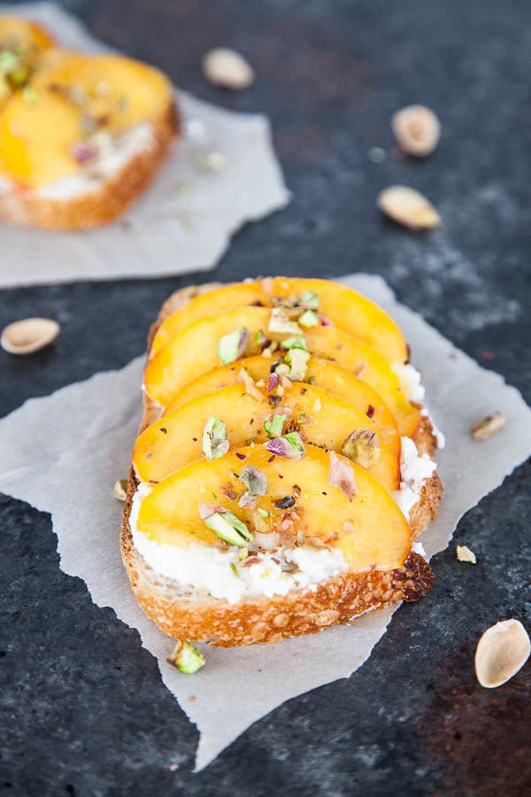 Enjoy peach ricotta toast for breakfast at the height of peach season - juicy sweet peaches are paired with creamy ricotta and crunchy salted pistachios.