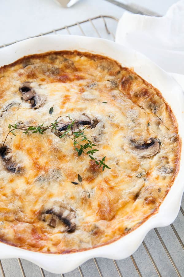Layers of mushrooms, eggs, and cheese ensure this crustless quiche is fluffy, creamy, savory goodness! Makes an excellent holiday brunch for your guests.