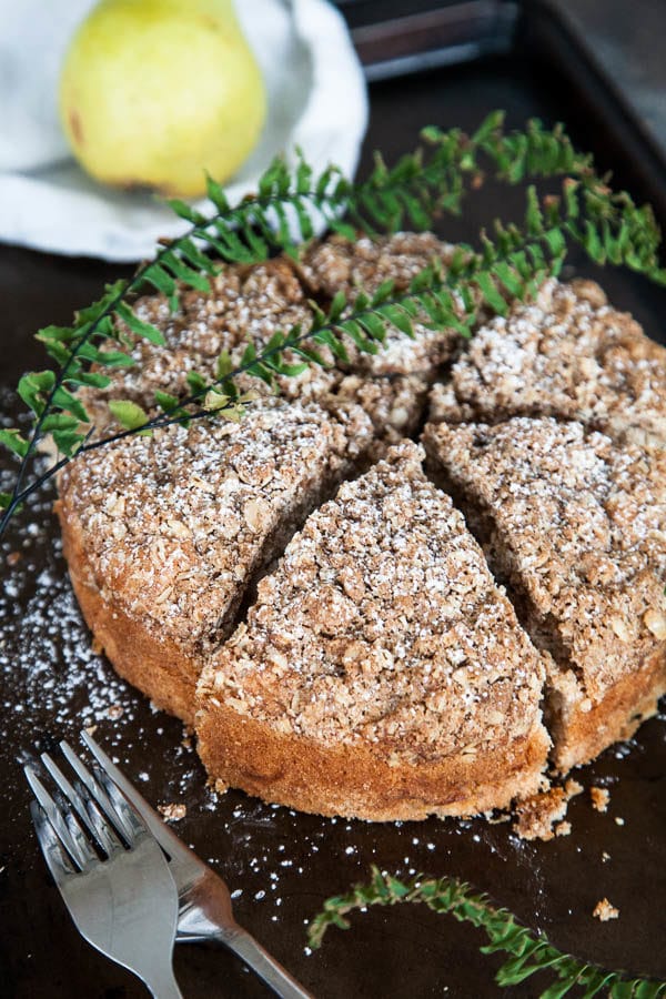 Spiced Pear Crumble Cake is packed with juicy pear, warm cinnamon, and generously sprinkled with a crumbly brown sugar oat topping.