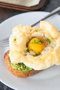Cloud Eggs are a fun new way to eat eggs for breakfast: you get light, fluffy whites with a perfectly runny yolk. The absolute best of both worlds.
