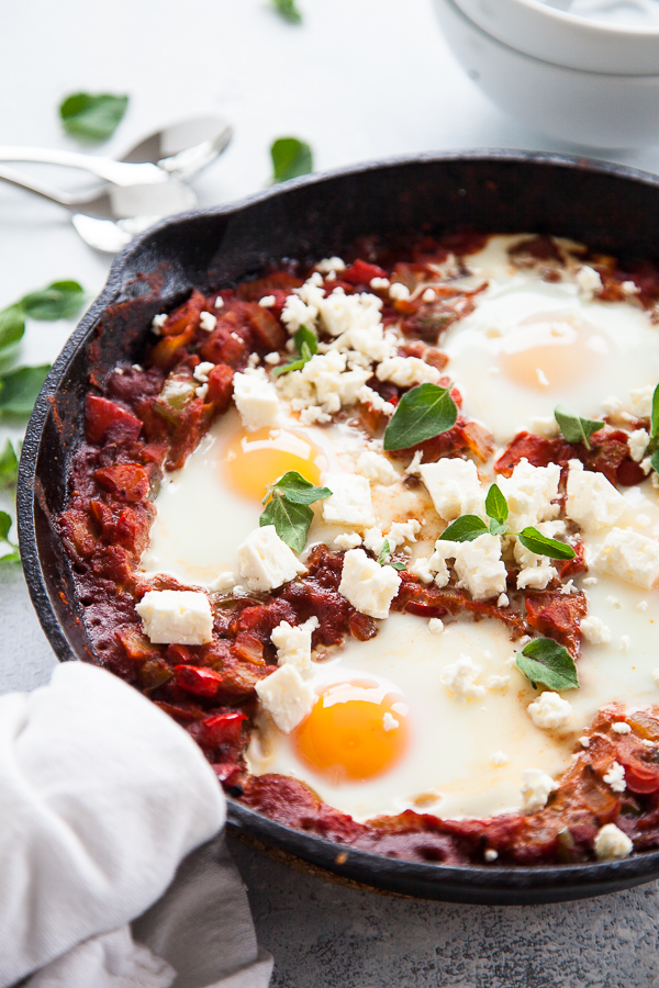Cast iron pan with Shakshuka and poached eggs